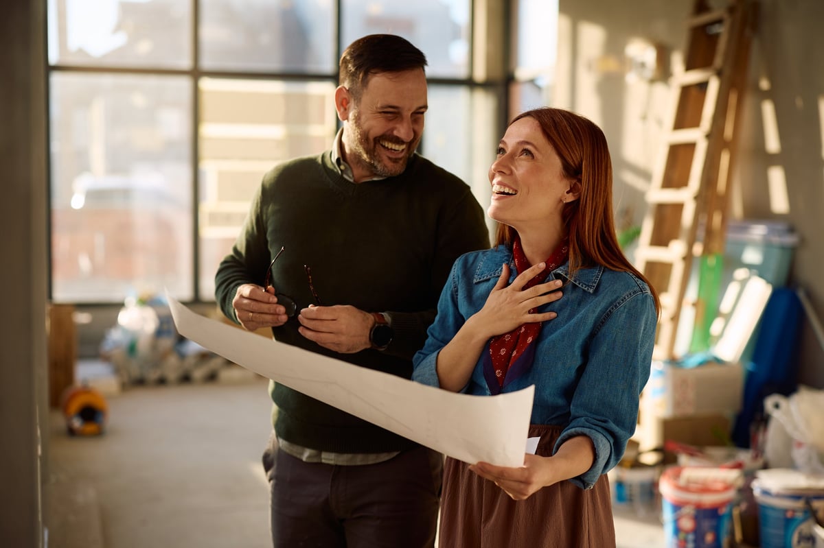 Homeowners reviewing renovation plans during a residential remodeling project